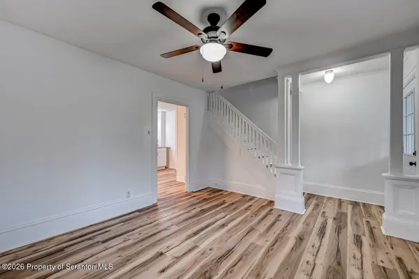 wooden floor in an empty room with a window