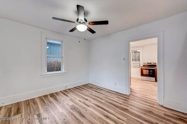 a view of livingroom with hardwood floor and kitchen view