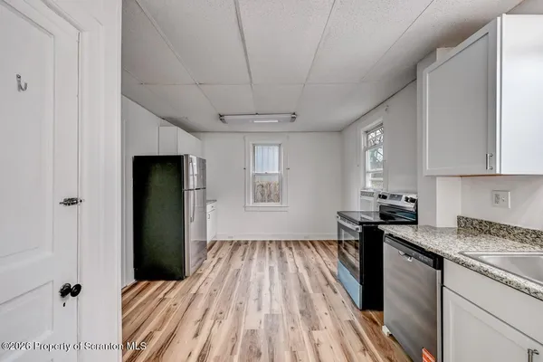 a kitchen with a sink a refrigerator freezer and a stove