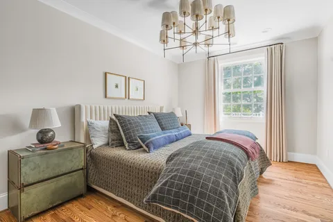 a bed sitting in a bedroom next to a window