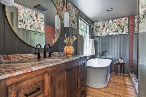a bathroom with a granite countertop sink and a mirror
