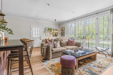 a living room with furniture and a floor to ceiling window