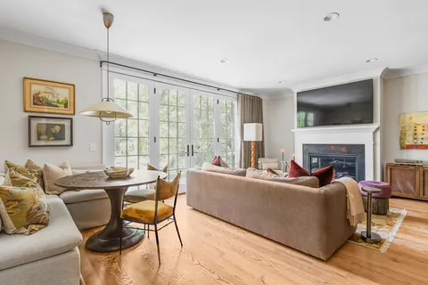 a living room with fireplace furniture and a flat screen tv