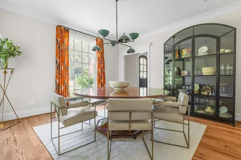 a living room with furniture a table and chairs