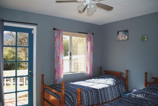 595 Evans Road Wofford Heights, CA 93285 - Photo 35 of 43 a bedroom with a bed and a window