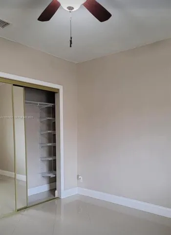 an empty room with a empty space and a ceiling fan