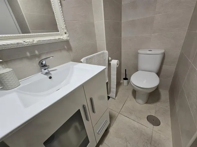 a bathroom with a sink mirror and toilet
