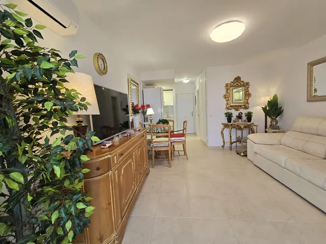 a living room with furniture and a lamp