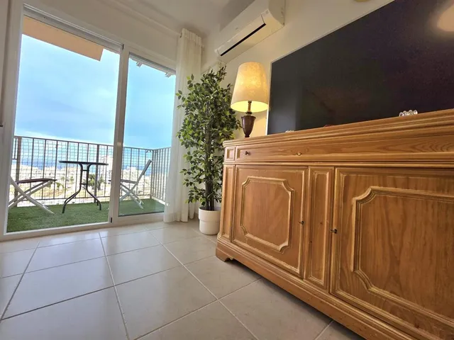 a view of a chairs and table in the balcony