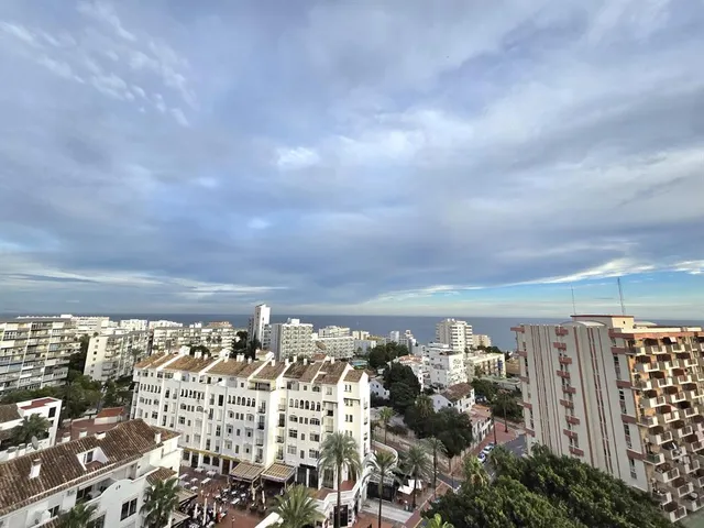a view of a city street lined with tall buildings