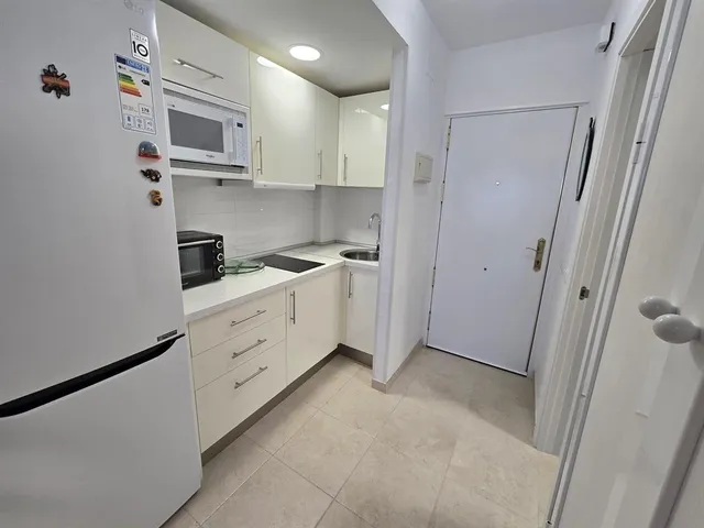 a view of a kitchen with electric appliances