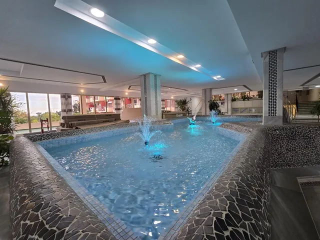 a view of swimming pool with a table and chairs