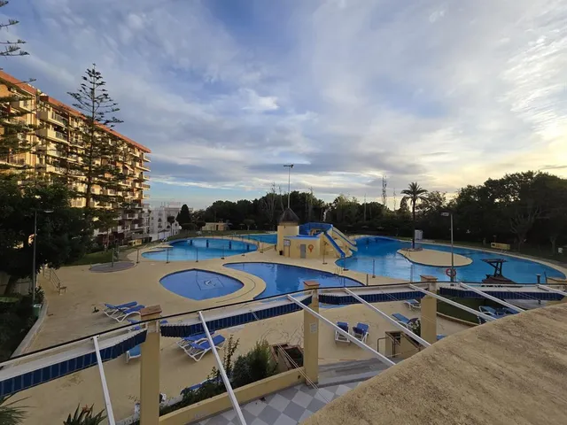 a swimming pool with outdoor seating and yard