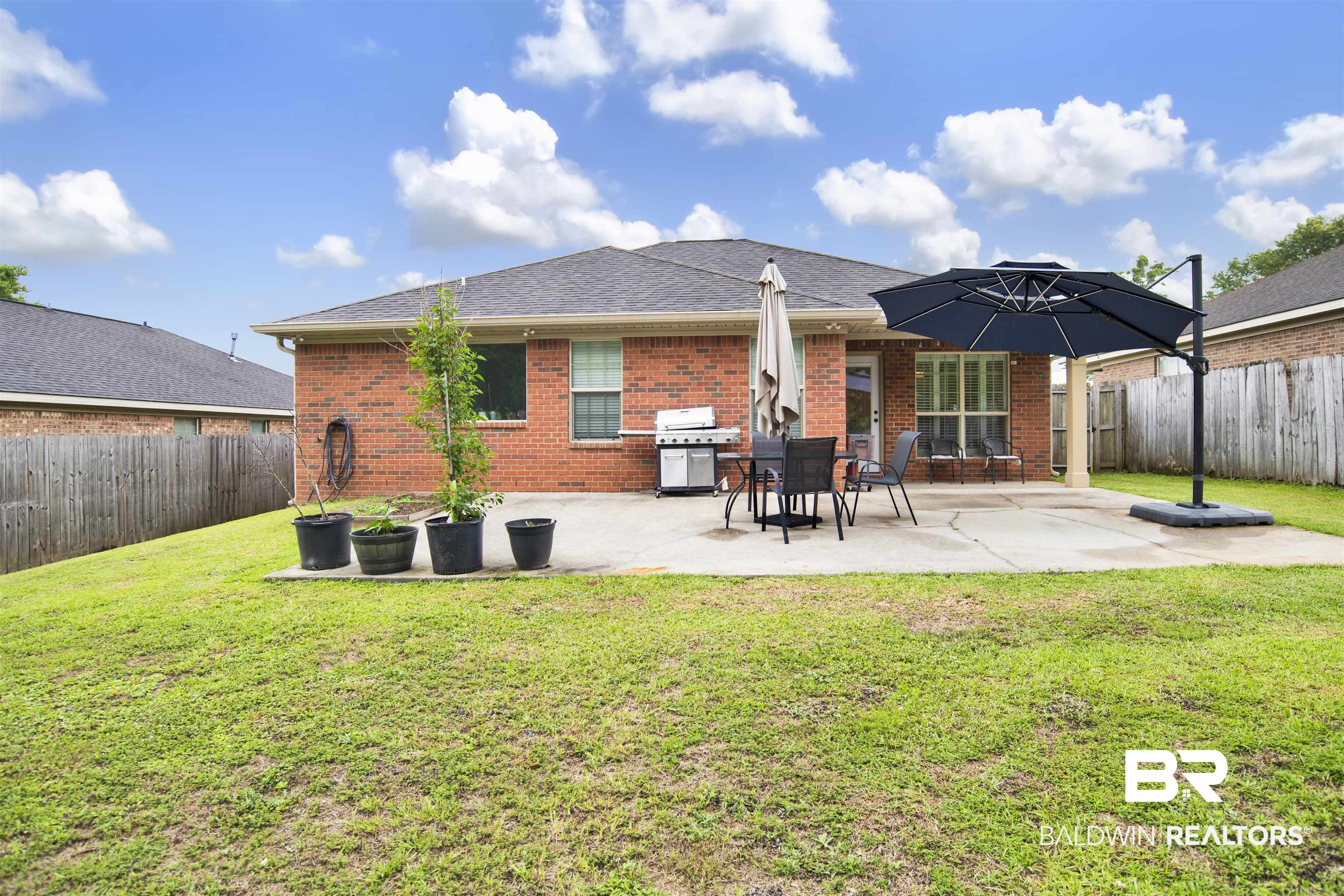 8542 Three Dean Way Mobile, AL 36695 - Photo 24 of 26 Rear view of house with brick siding, a patio, and a shingled roof