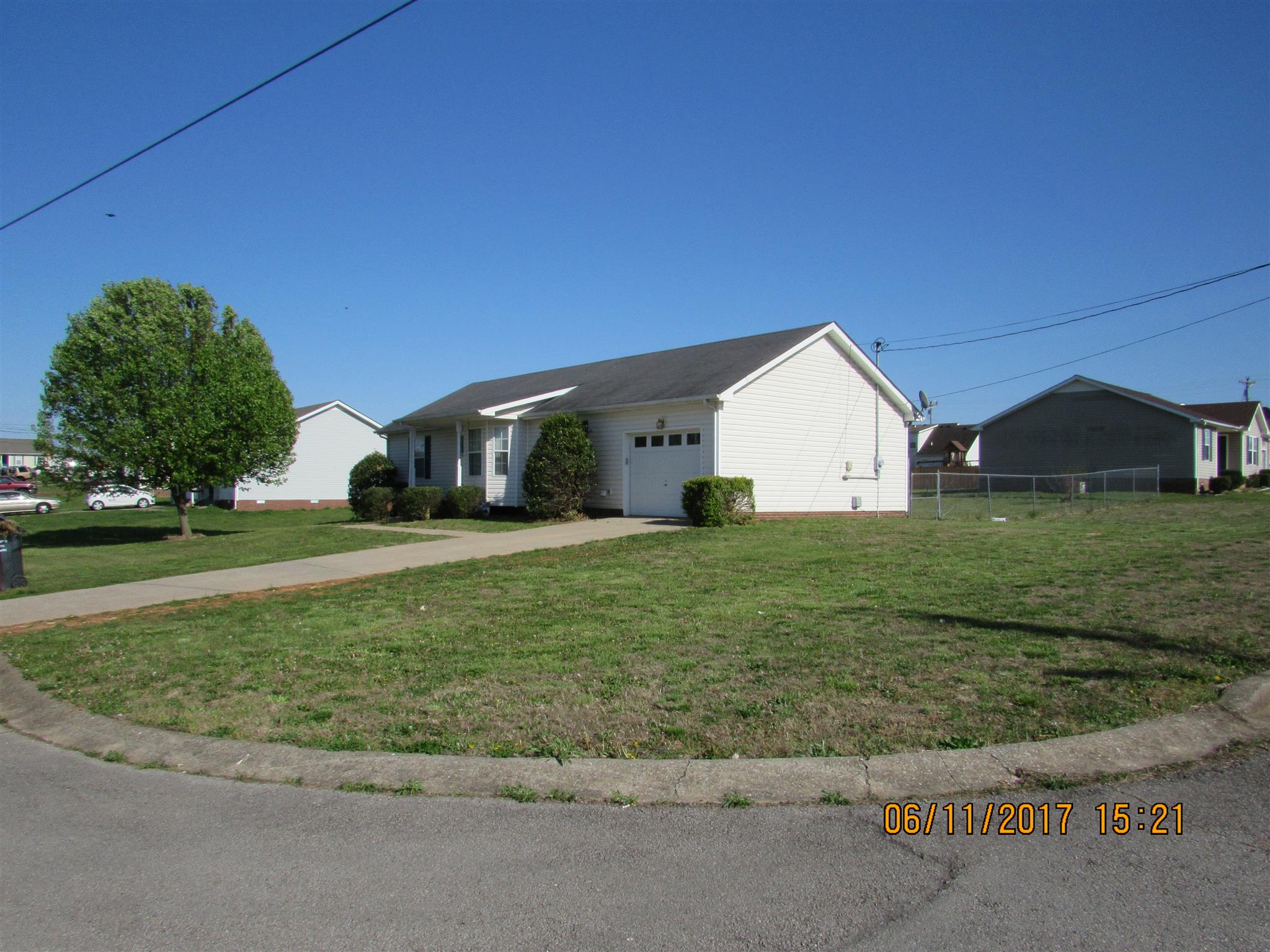 211 Ruf Drive Oak Grove, KY 42262 - Photo 3 of 27 a view of a white house next to a yard with big trees