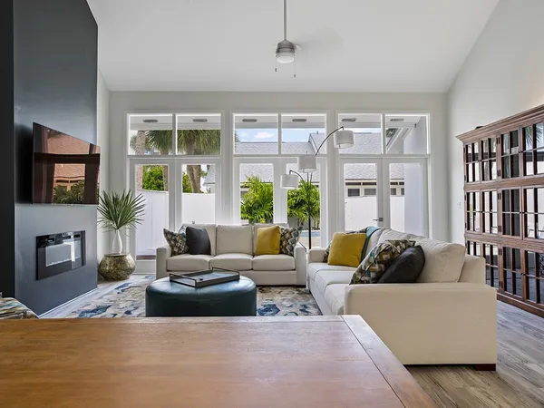 a living room with fireplace furniture and a large window