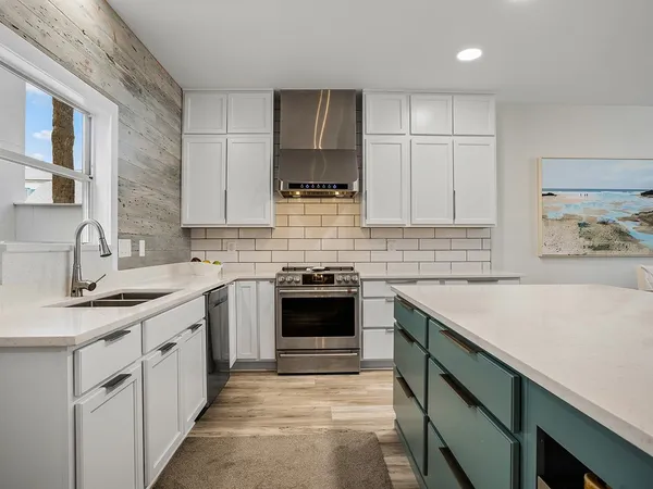 a kitchen with a sink stove and cabinets