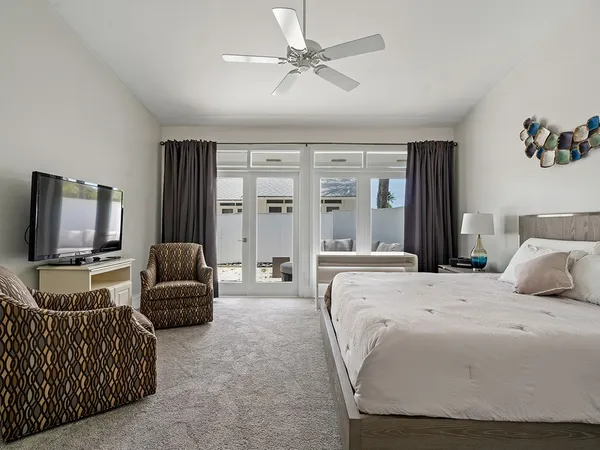 a bedroom with a balcony a bed and a chandelier