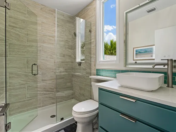 a bathroom with a sink toilet and shower