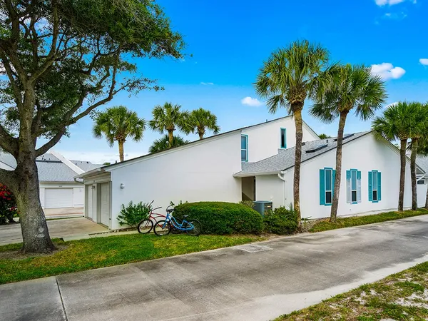 a front view of a house with a yard and a garage