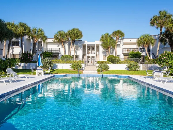 a swimming pool view with a outdoor seating