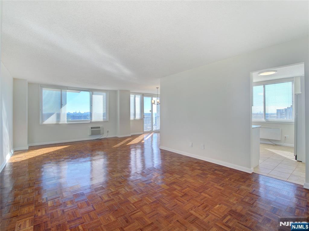 160 Overlook Avenue, Unit 17C Hackensack, NJ 07601 - Photo 13 of 30 an empty room with wooden floor and windows
