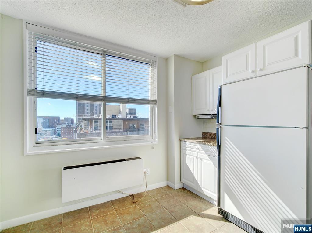 160 Overlook Avenue, Unit 17C Hackensack, NJ 07601 - Photo 24 of 30 a kitchen with a refrigerator and a more cabinets