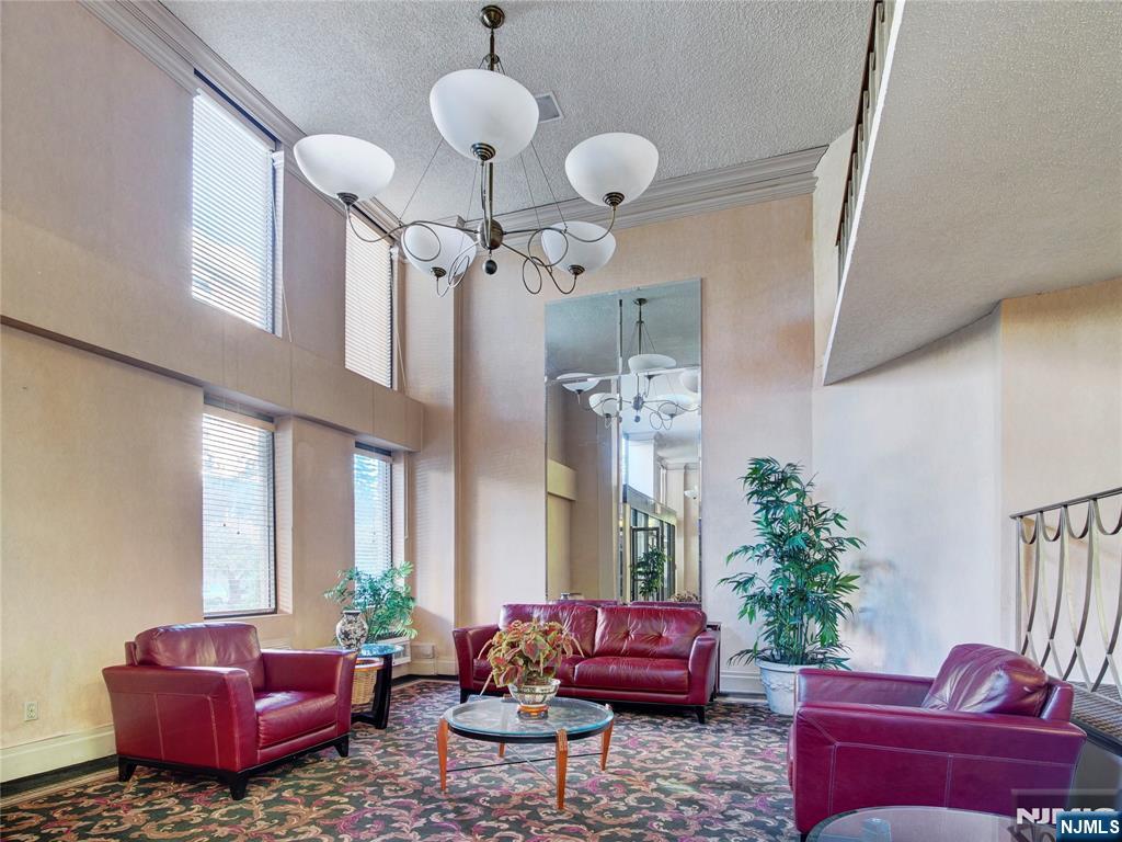 160 Overlook Avenue, Unit 17C Hackensack, NJ 07601 - Photo 3 of 30 a living room with furniture potted plant and a chandelier