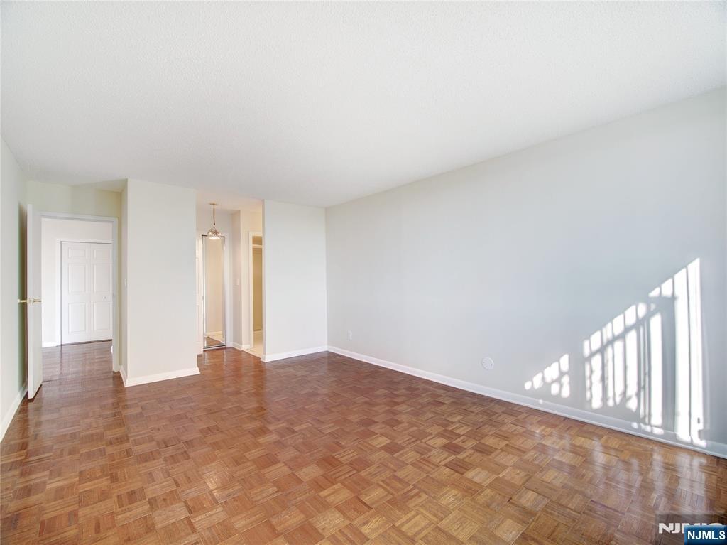 160 Overlook Avenue, Unit 17C Hackensack, NJ 07601 - Photo 9 of 30 a view of an empty room and wooden floor