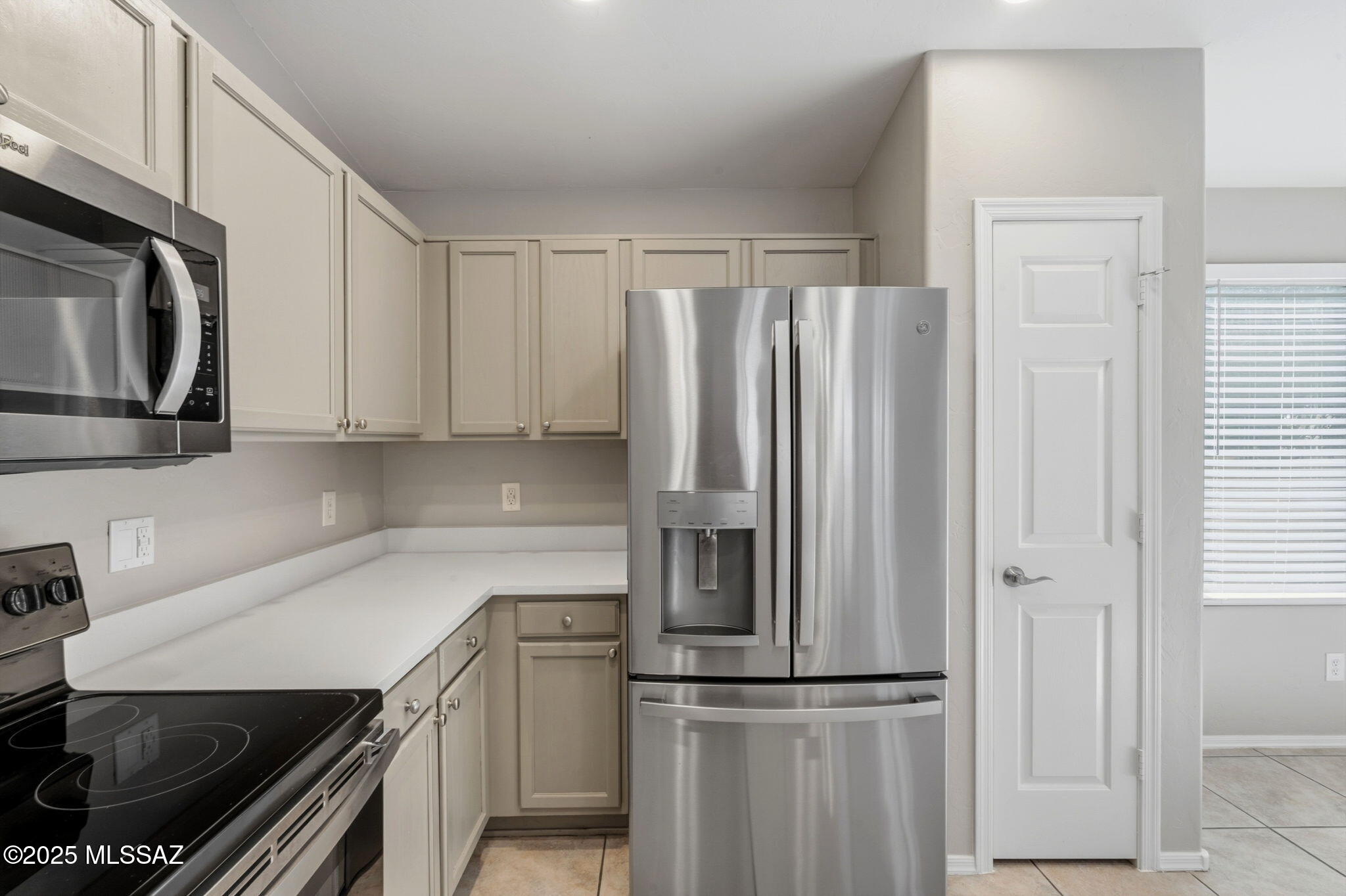8244 South Lost Mountain Road Tucson, AZ 85747 - Photo 10 of 41 a kitchen with stainless steel appliances a refrigerator sink and microwave