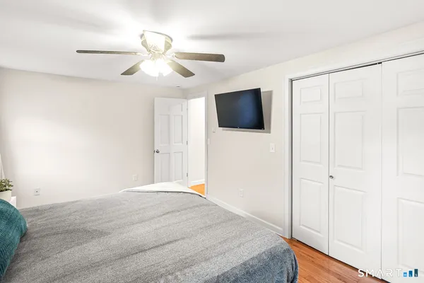 a bedroom with a large bed and a flat screen tv