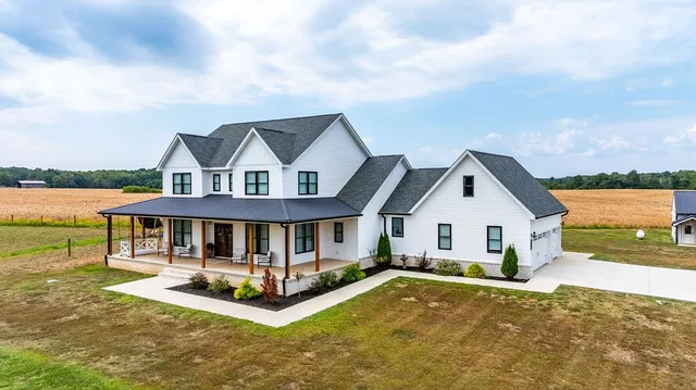 a front view of a house with a yard table and chairs