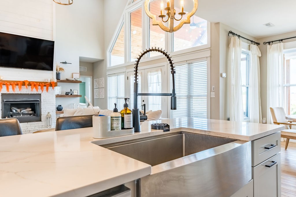 3765 S Road Cadiz, KY 42211 - Photo 19 of 78 a large white kitchen with a large window and stainless steel appliances