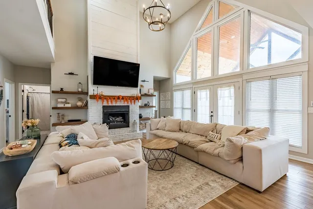 a living room with furniture and a chandelier