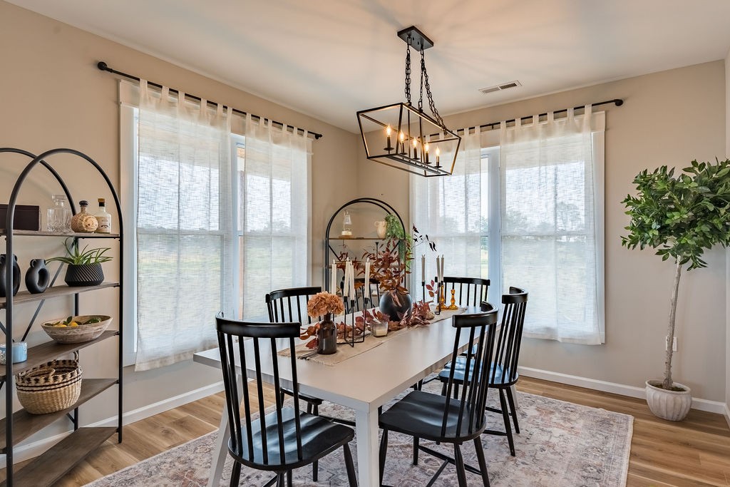 3765 S Road Cadiz, KY 42211 - Photo 25 of 78 a view of a dining room with furniture window and wooden floor