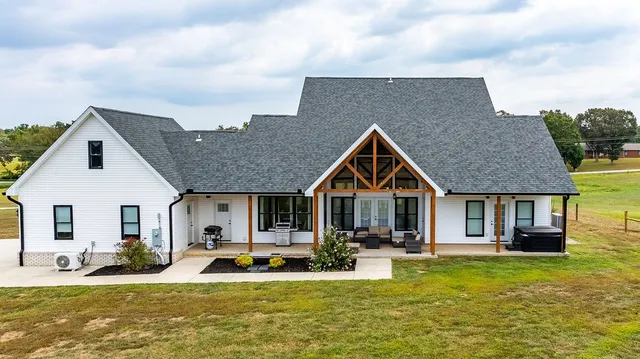 a large white kitchen with a large window and stainless steel appliances