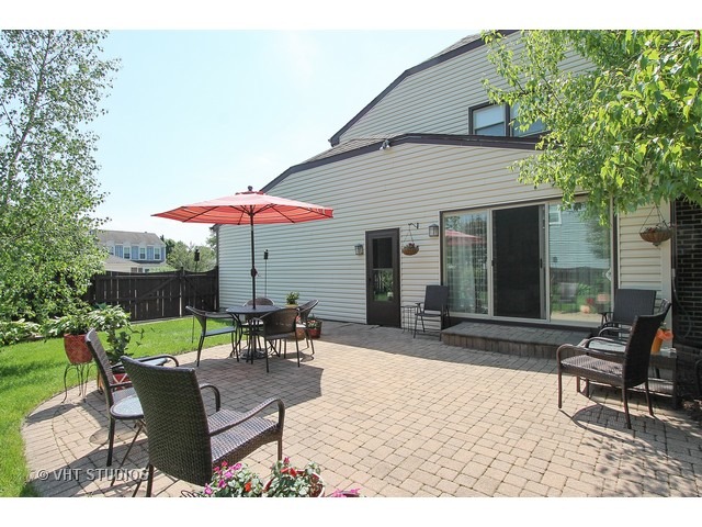 910 Dannet Road Buffalo Grove, IL 60089 - Photo 22 of 25 a view of a house with backyard sitting area and furniture