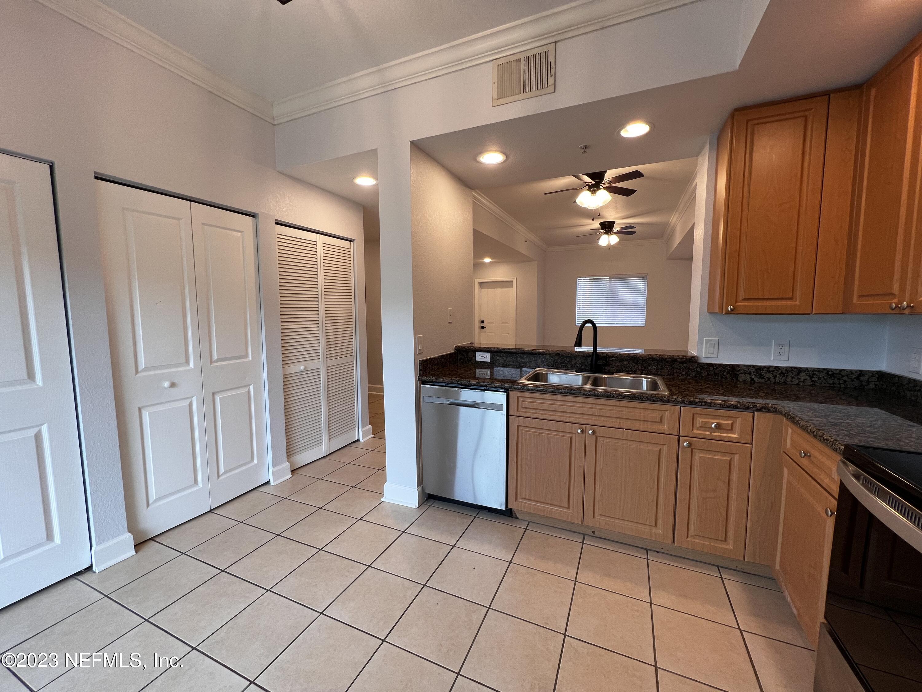 9745 Touchton Road, Unit 1702 Jacksonville, FL 32246 - Photo 11 of 62 a large kitchen with a sink and cabinets