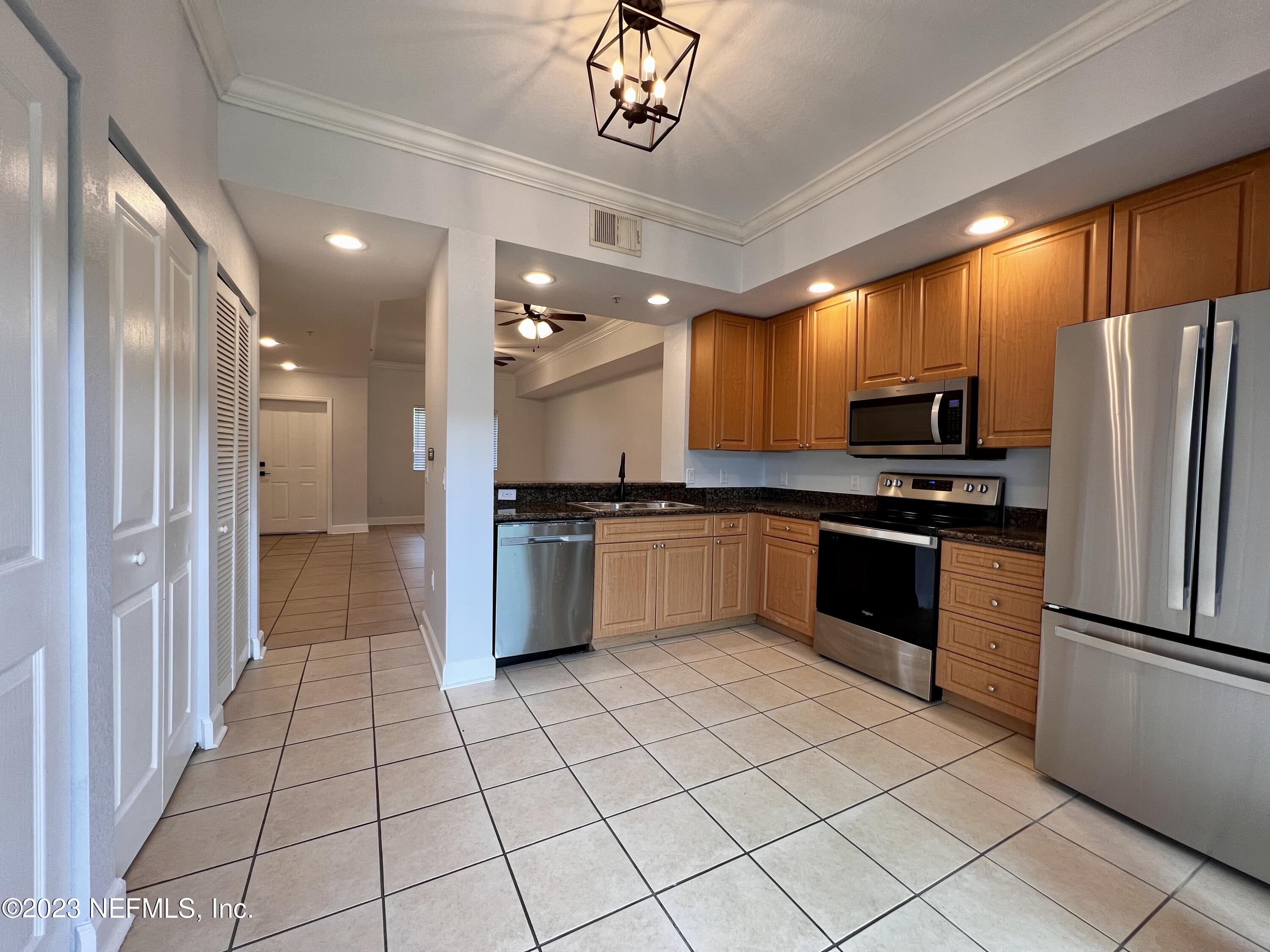 9745 Touchton Road, Unit 1702 Jacksonville, FL 32246 - Photo 15 of 62 a kitchen with stainless steel appliances a refrigerator sink and microwave