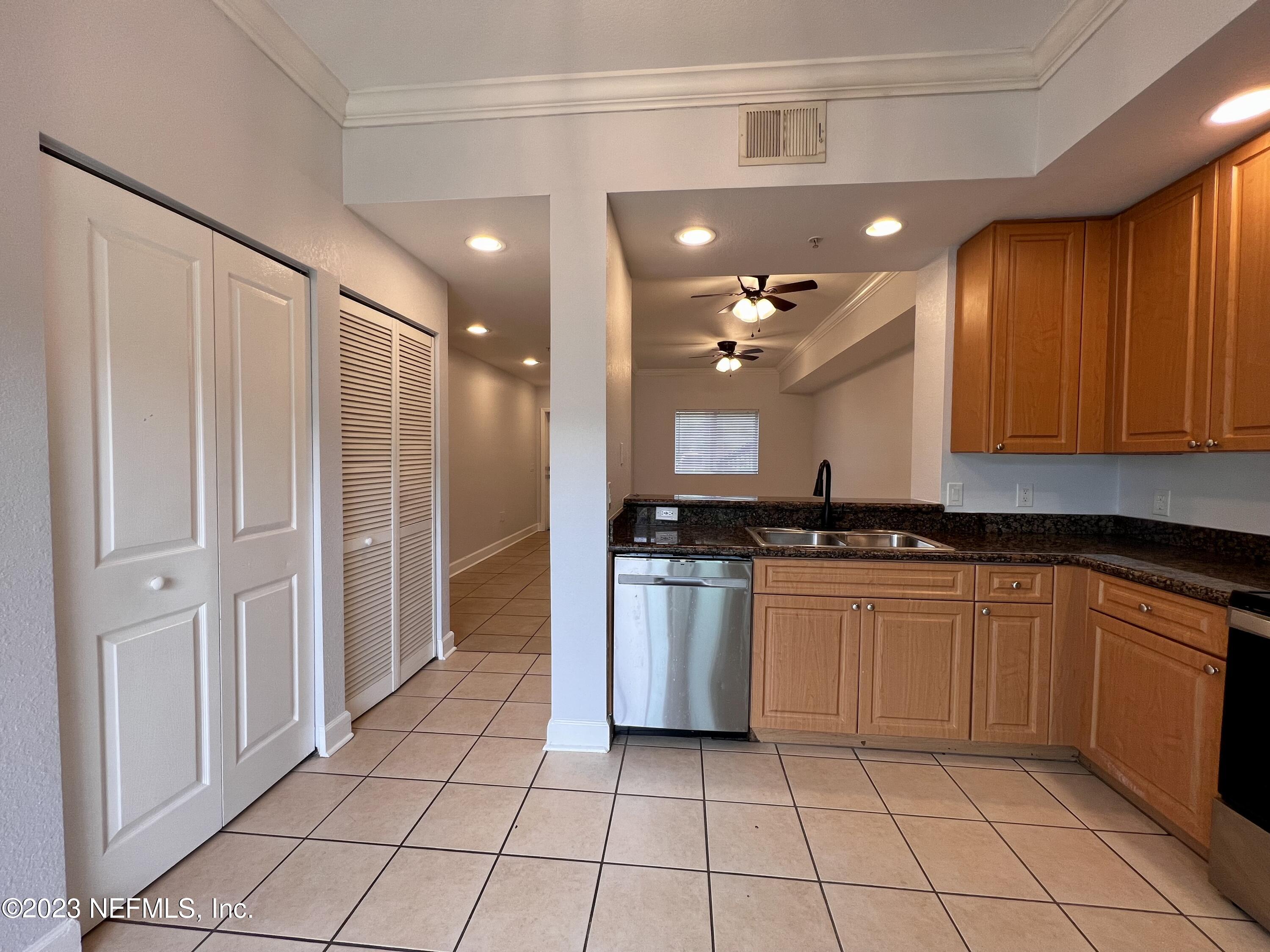 9745 Touchton Road, Unit 1702 Jacksonville, FL 32246 - Photo 16 of 62 a large kitchen with granite countertop a stove a sink dishwasher and a refrigerator