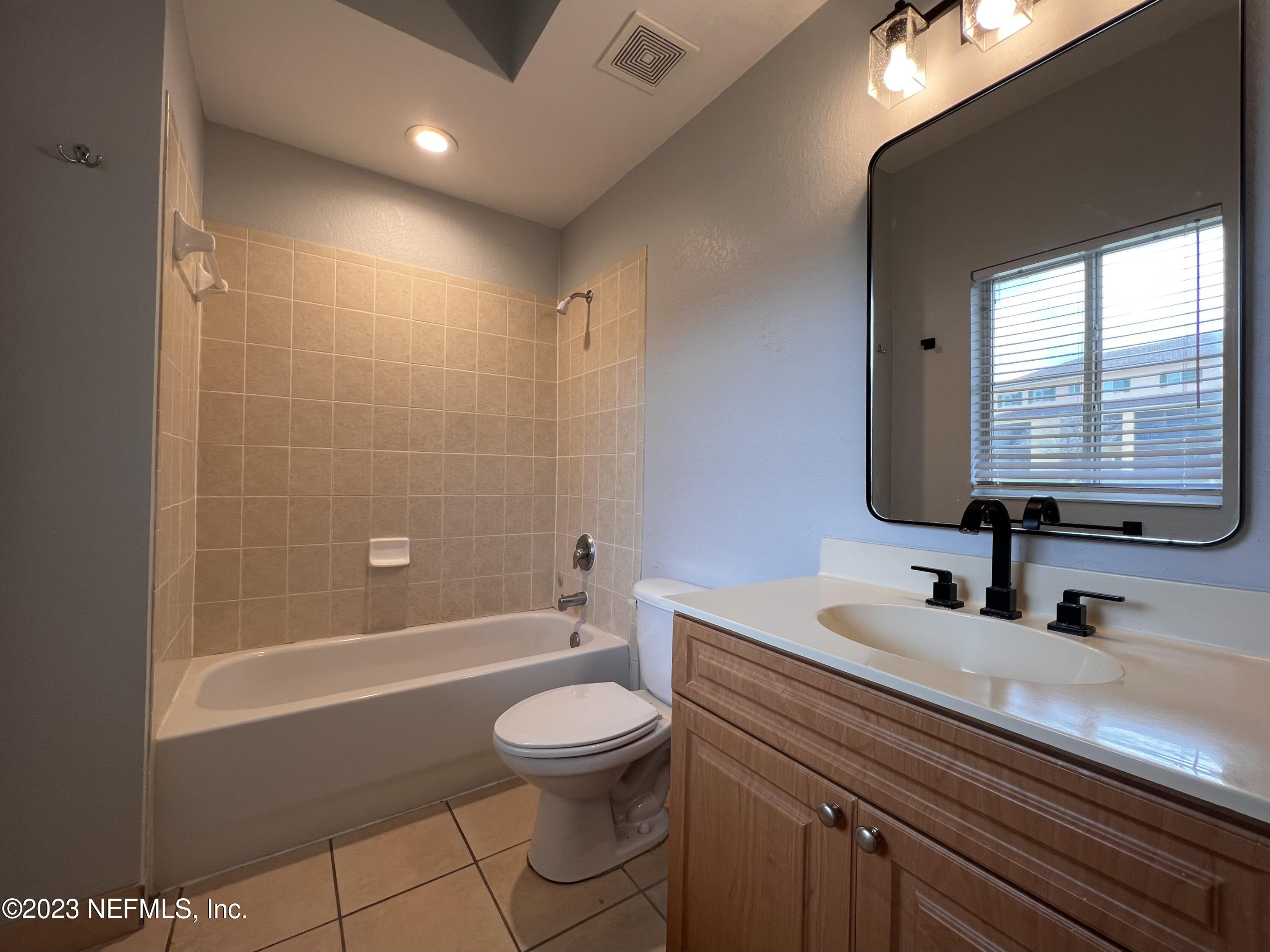 9745 Touchton Road, Unit 1702 Jacksonville, FL 32246 - Photo 29 of 62 a bathroom with a sink a toilet and shower