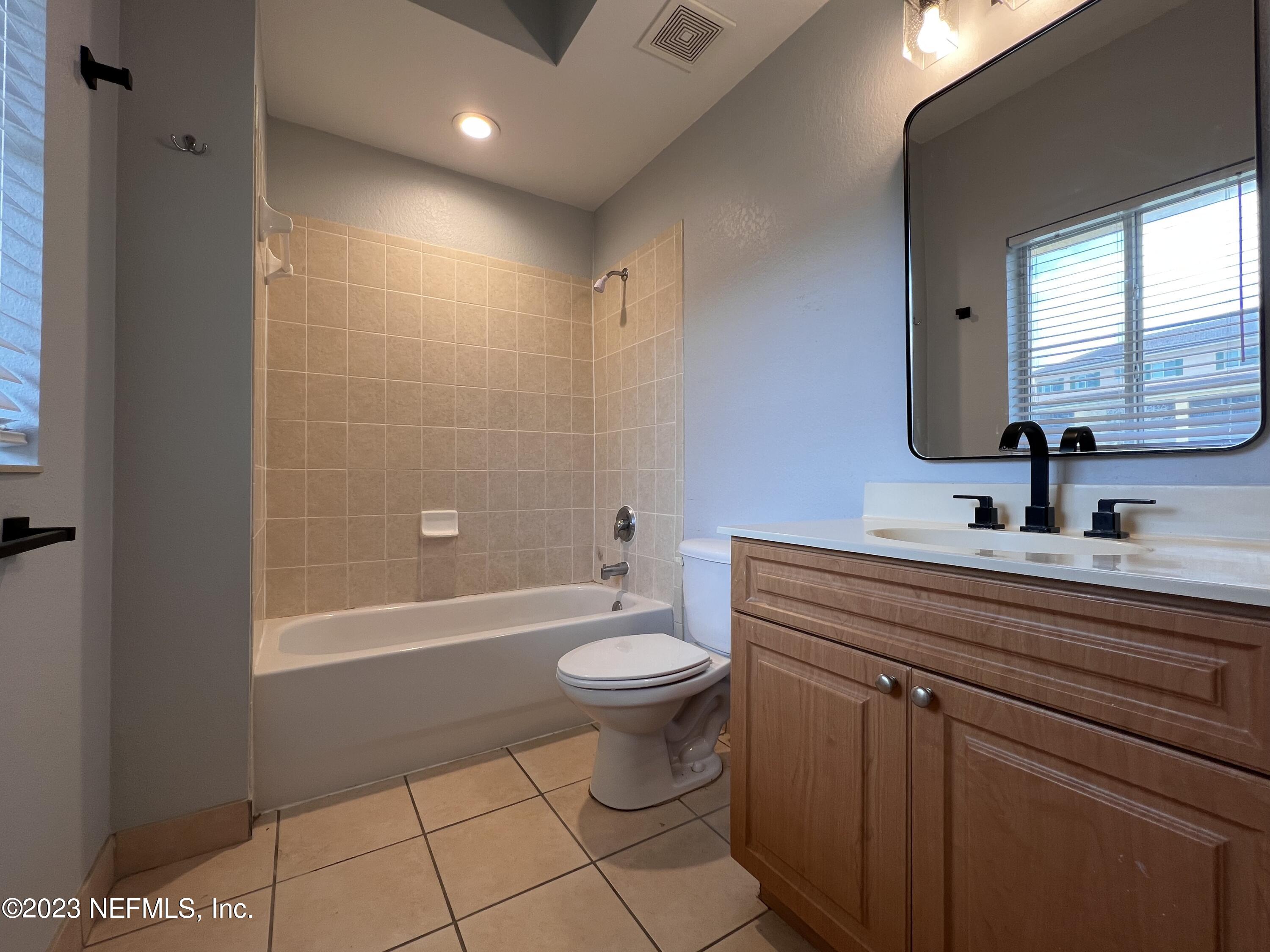9745 Touchton Road, Unit 1702 Jacksonville, FL 32246 - Photo 31 of 62 a bathroom with a sink a toilet and shower