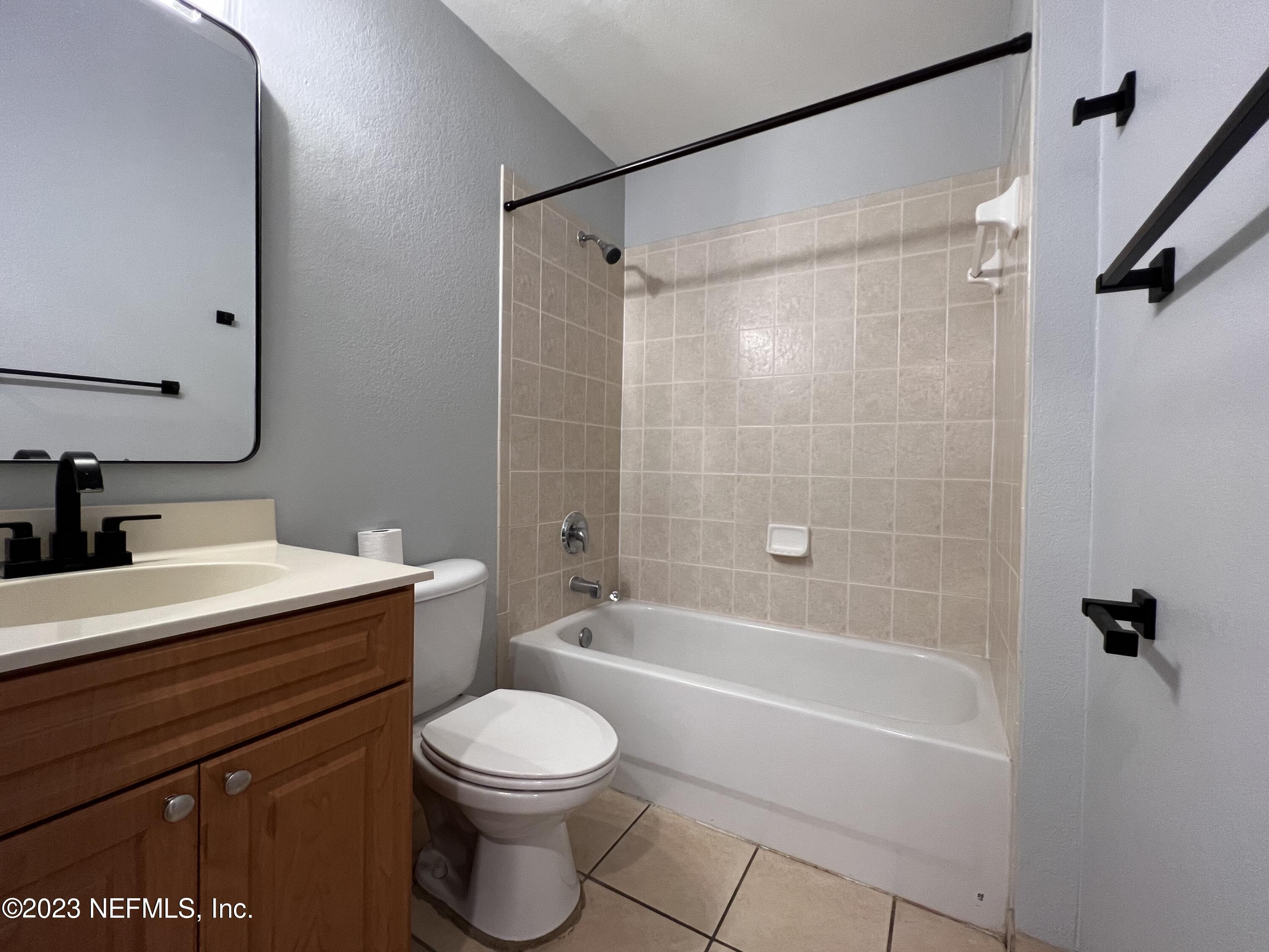 9745 Touchton Road, Unit 1702 Jacksonville, FL 32246 - Photo 32 of 62 a bathroom with a sink a toilet and shower