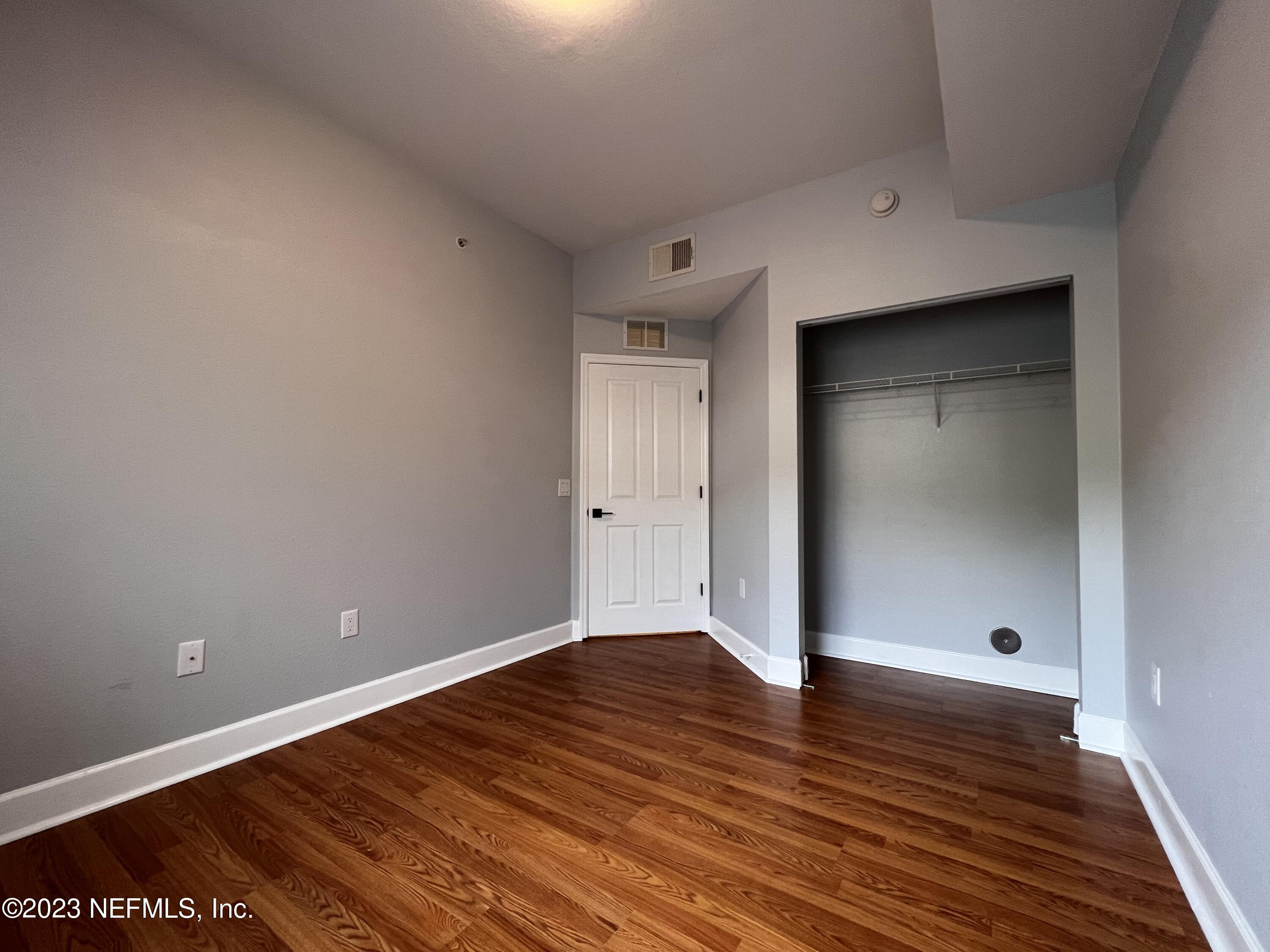 9745 Touchton Road, Unit 1702 Jacksonville, FL 32246 - Photo 34 of 62 a view of an empty room with wooden floor