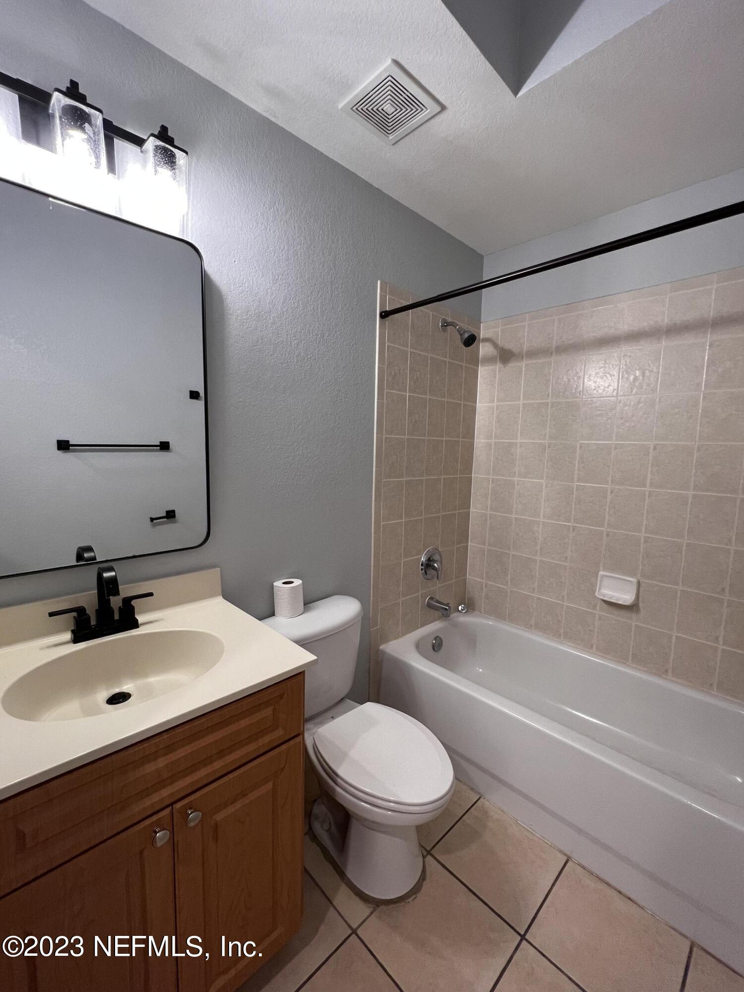 9745 Touchton Road, Unit 1702 Jacksonville, FL 32246 - Photo 35 of 62 a bathroom with a sink a toilet and shower
