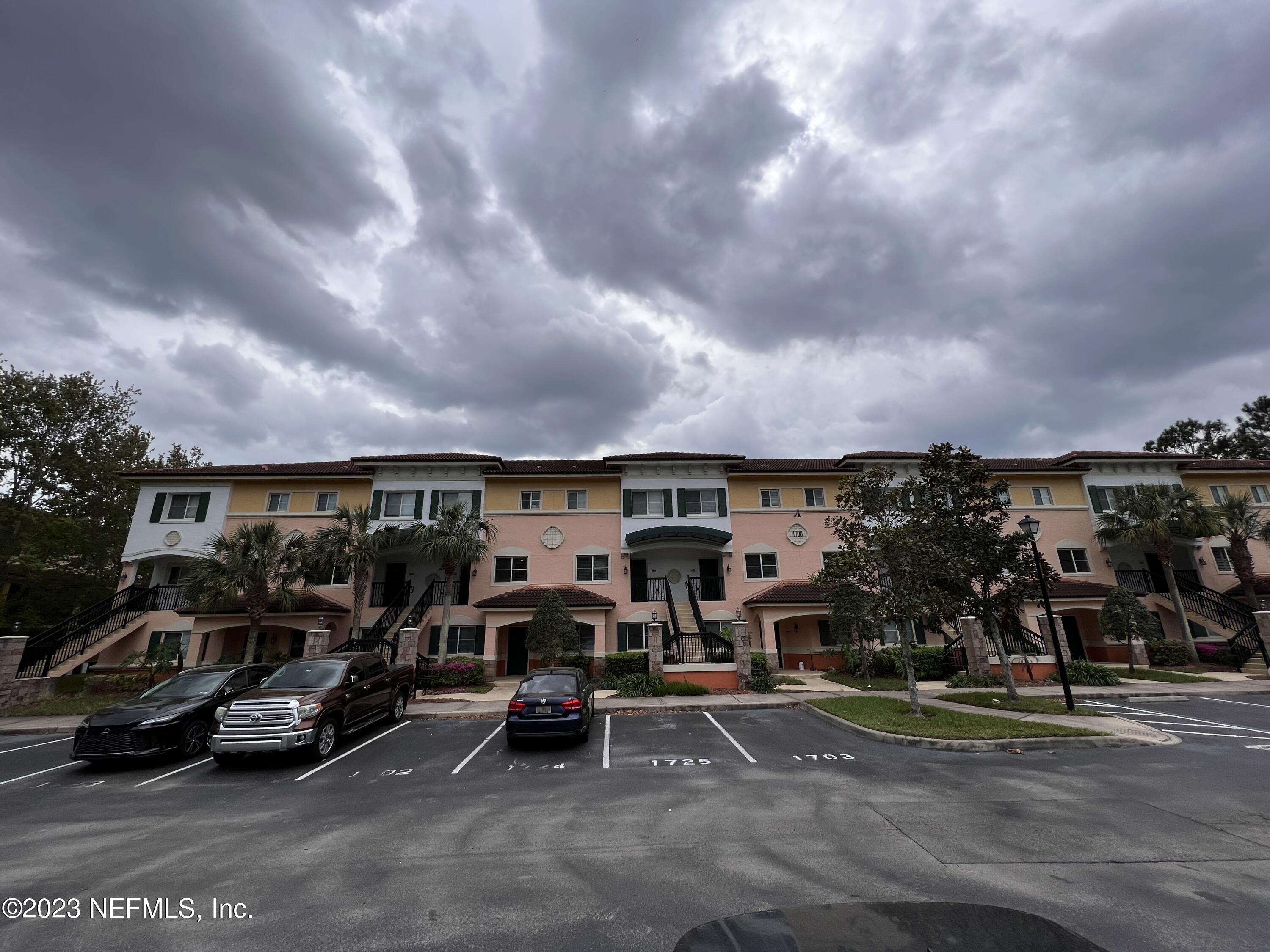 9745 Touchton Road, Unit 1702 Jacksonville, FL 32246 - Photo 39 of 62 a view of parking with cars parked