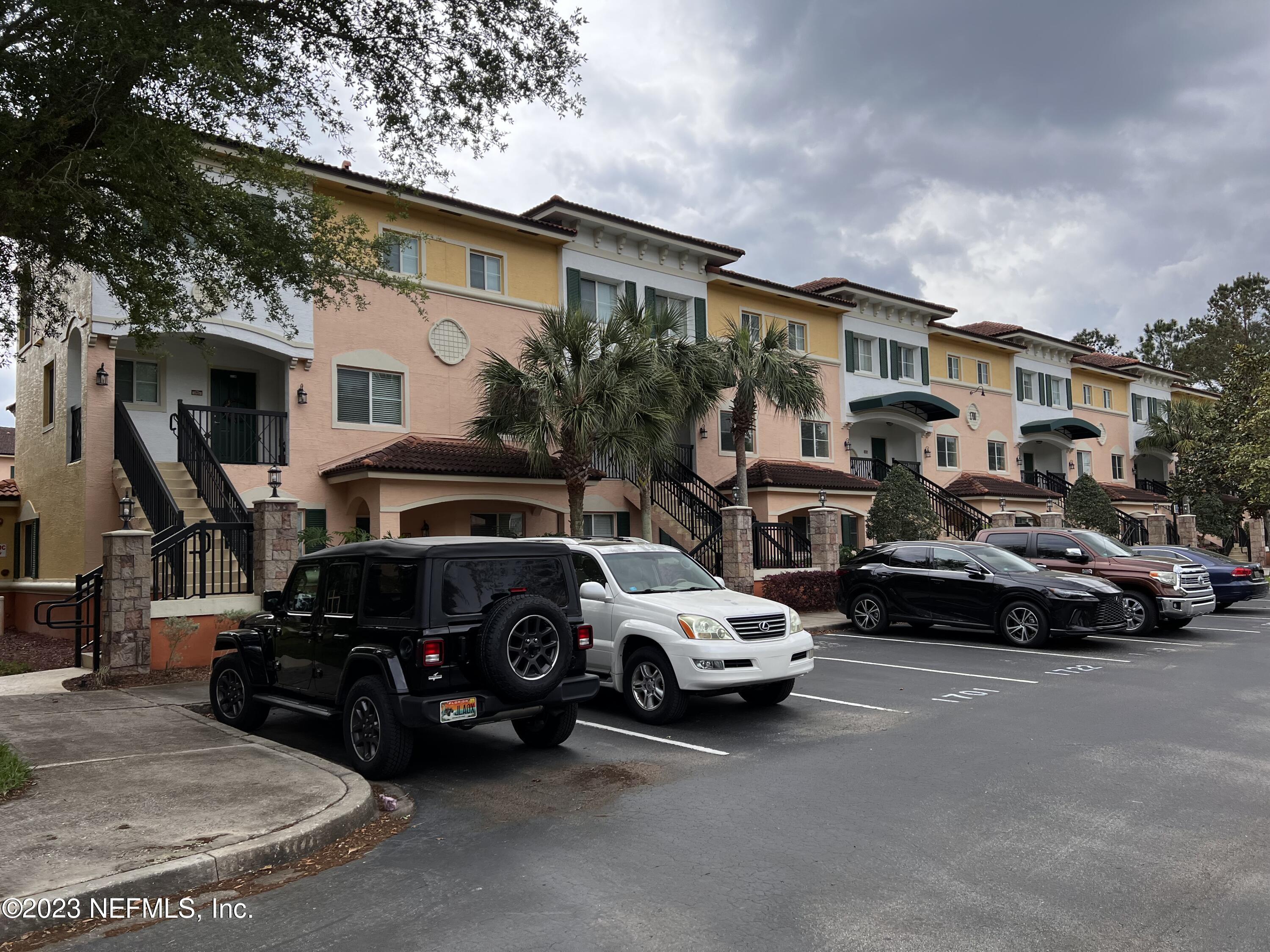 9745 Touchton Road, Unit 1702 Jacksonville, FL 32246 - Photo 4 of 62 a view of a cars park in front of house