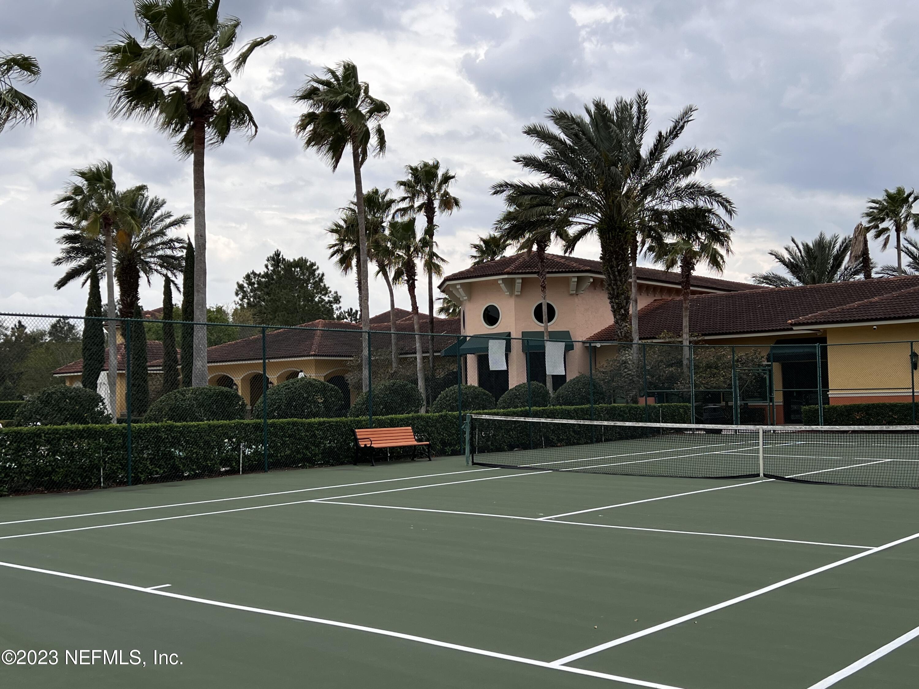 9745 Touchton Road, Unit 1702 Jacksonville, FL 32246 - Photo 42 of 62 a view of a tennis court with palm trees