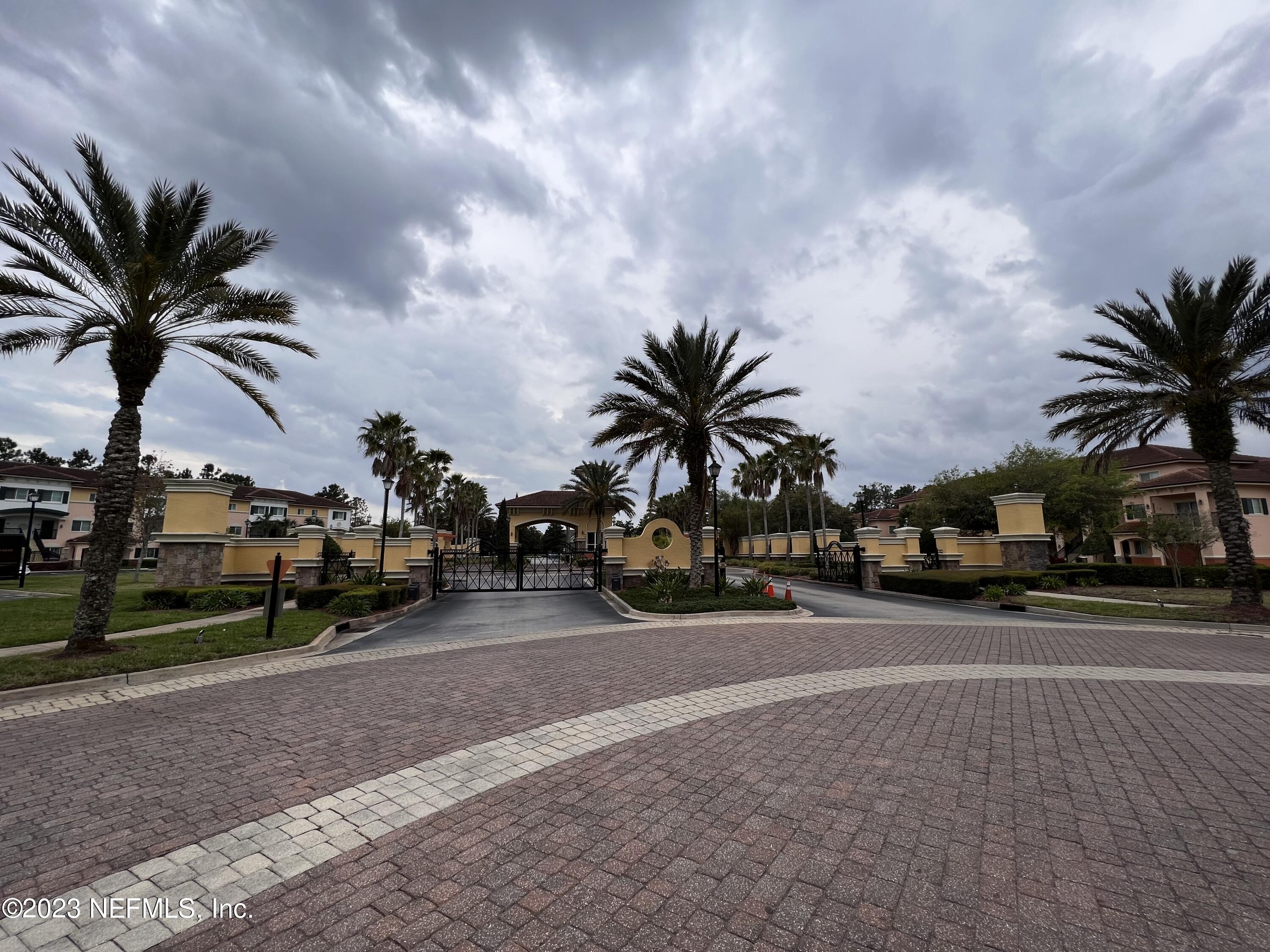 9745 Touchton Road, Unit 1702 Jacksonville, FL 32246 - Photo 43 of 62 a view of a street with a cars parked and a bike