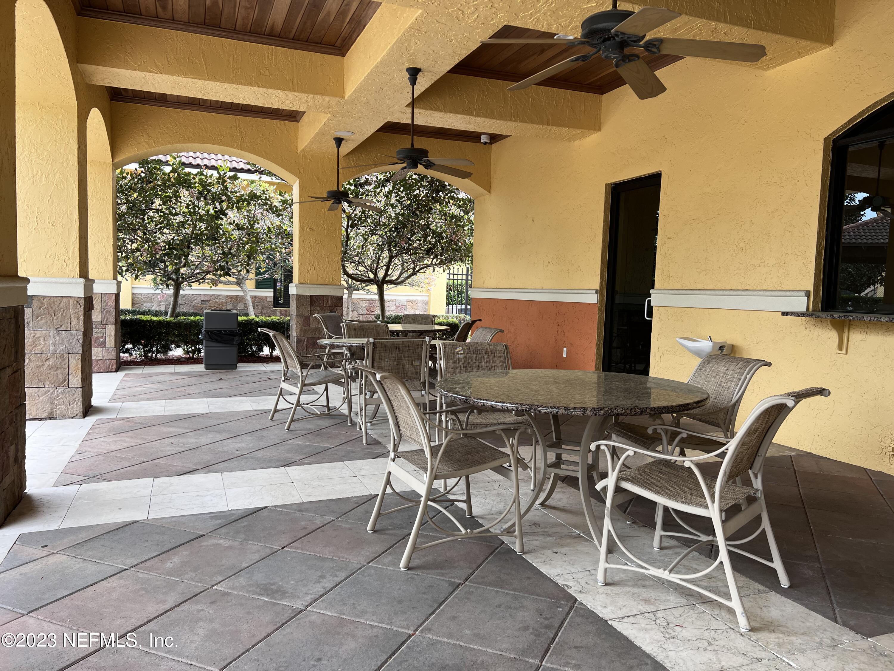 9745 Touchton Road, Unit 1702 Jacksonville, FL 32246 - Photo 50 of 62 a patio with a table and chairs and potted plants